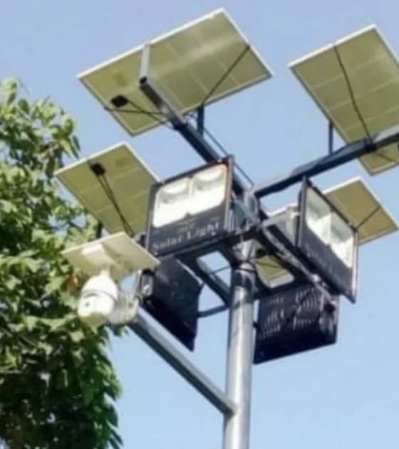 Multi-panel solar floodlight mast with integrated CCTV camera