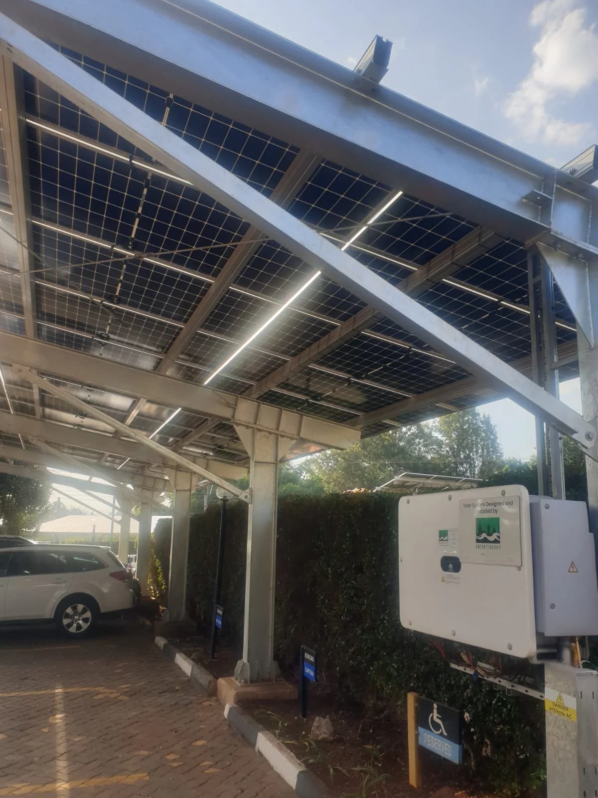 Solar carport structure with integrated inverter